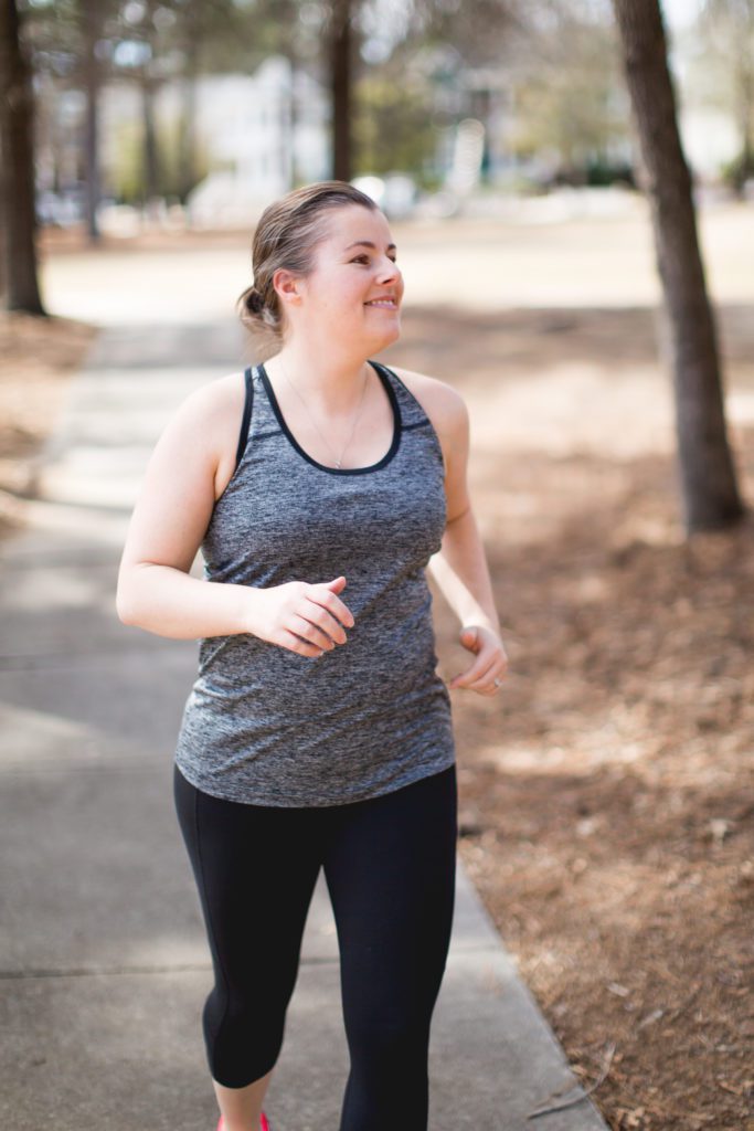 start working out again - a woman leisurely jogging through a park